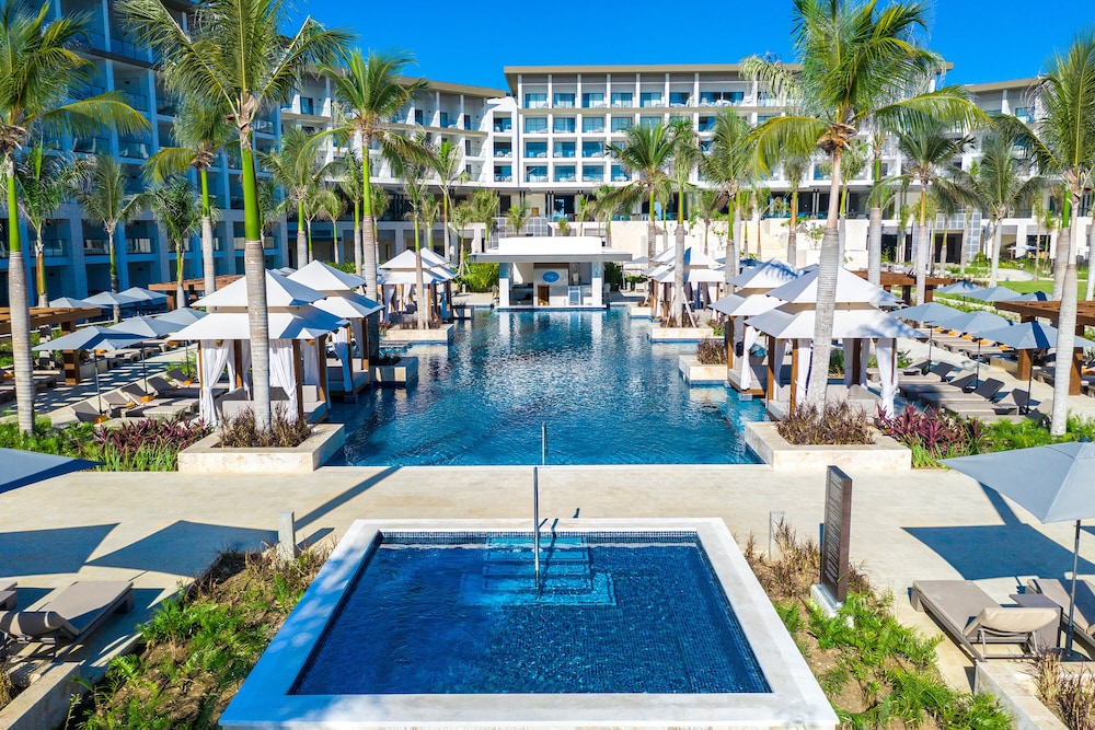 Beachfront pool and palm trees at one of the best Dominican Republic all inclusive resorts in Punta Cana