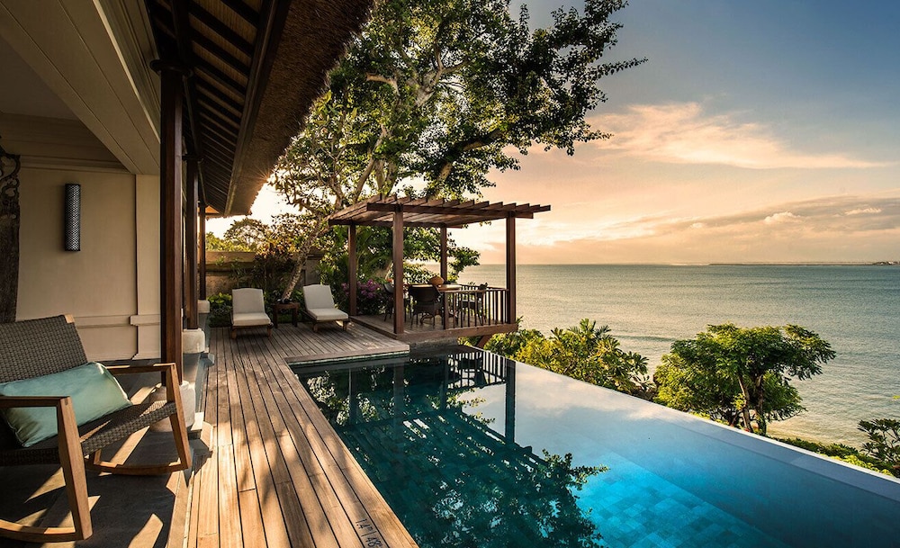 Four Seasons Resort Bali at Jimbaran Bay, one of the best Bali hotels, with thatched-roof private plunge-pool villas terraced above the calm bay