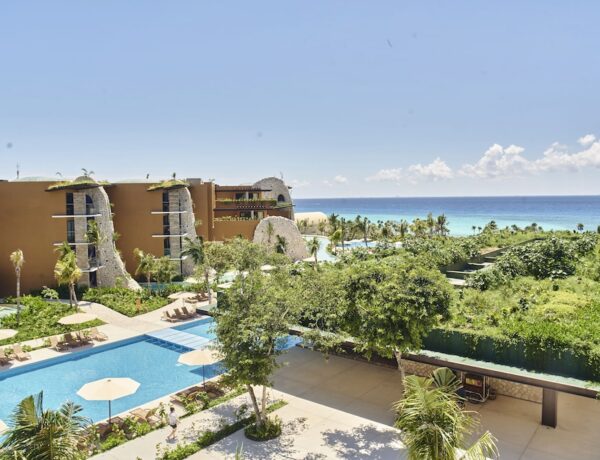 Beachfront pool and palm-lined sand at one of the top Riviera Maya all inclusive resorts in Mexico