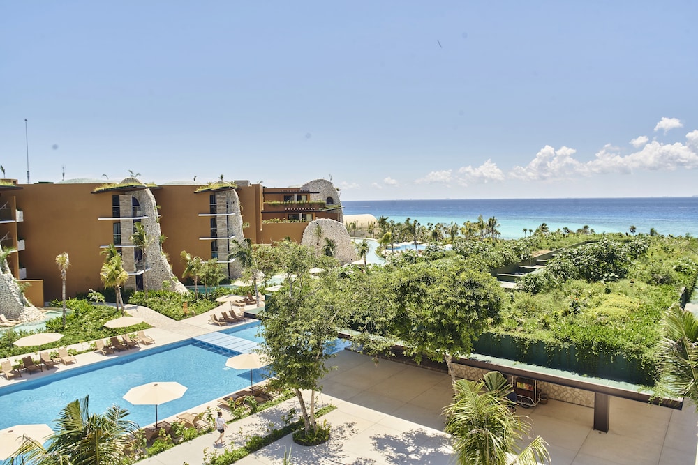 Beachfront pool and palm-lined sand at one of the top Riviera Maya all inclusive resorts in Mexico