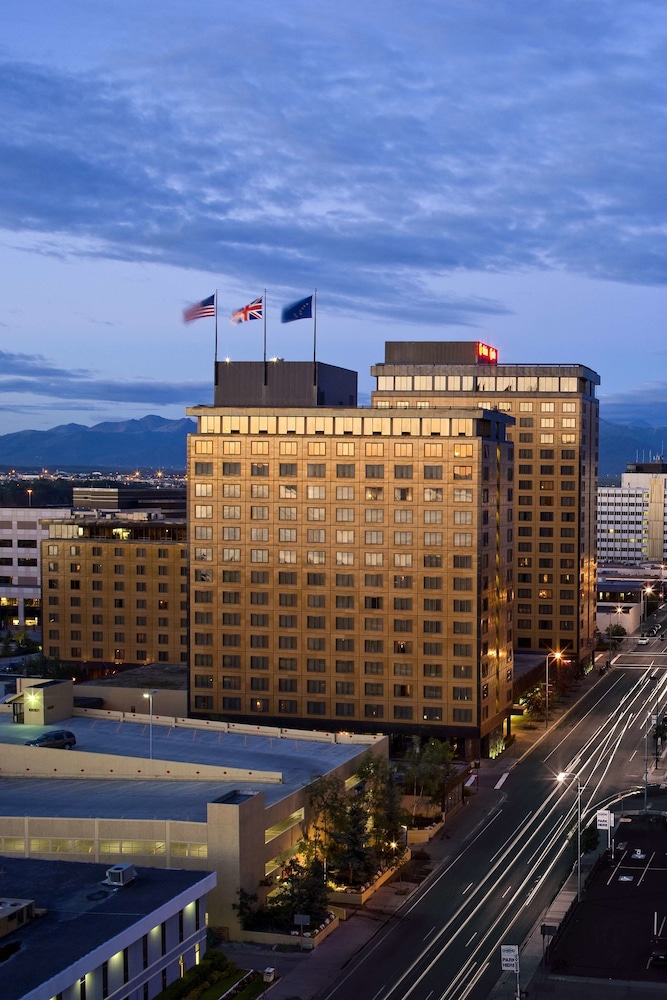 Hotel Captain Cook, one of the best full-service downtown Anchorage hotels, rising above the city near Cook Inlet