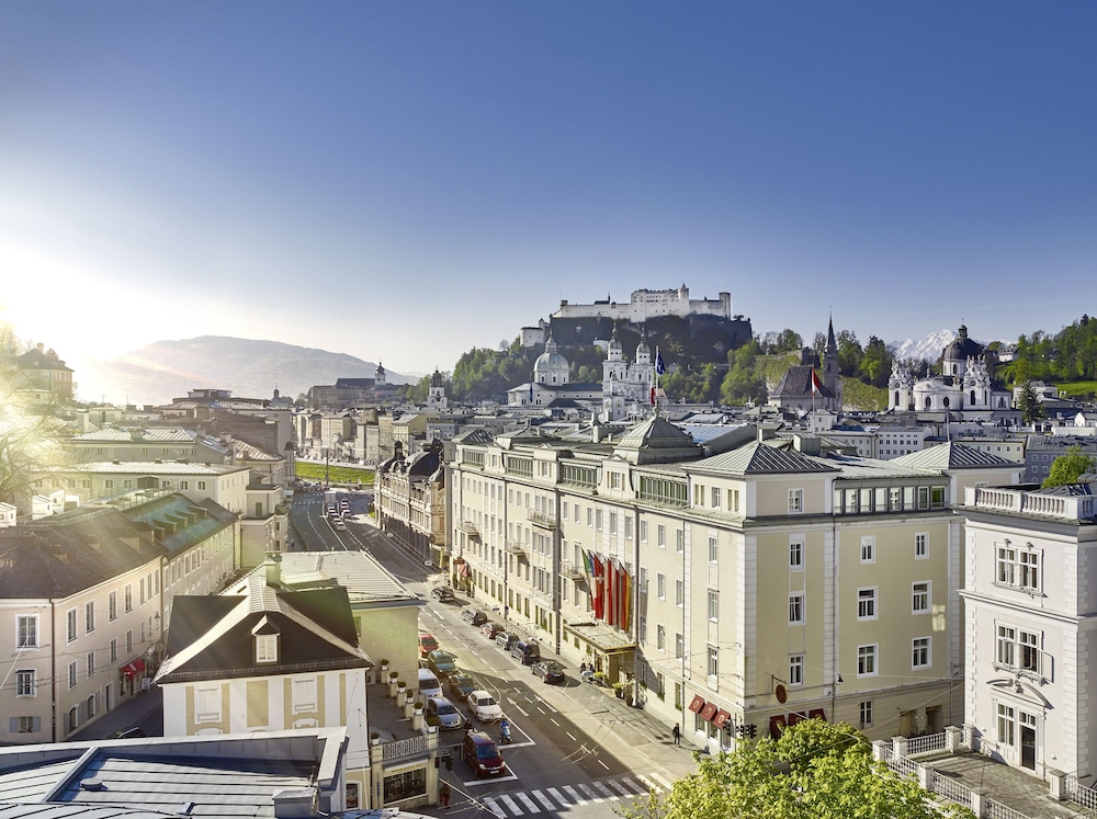 The riverside facade of Hotel Sacher Salzburg, one of the best Salzburg hotels, on the Schwarzstrasse embankment near Mirabell Gardens